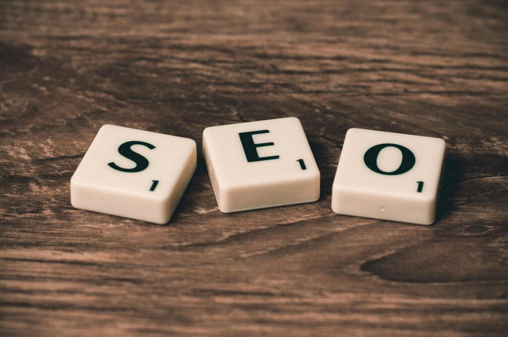 alphabet tiles that spell out SEO on a brown surface